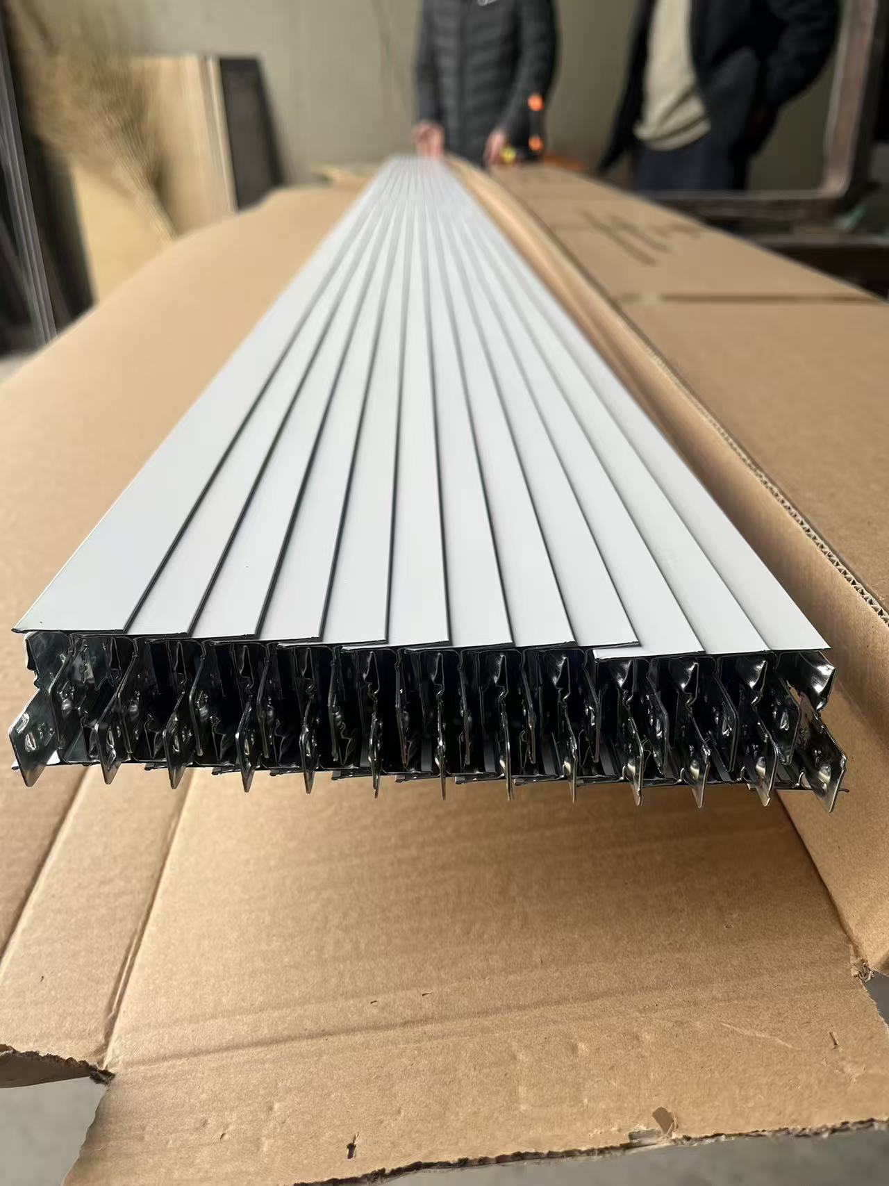 Painted T-grid ceiling keel packed for delivery